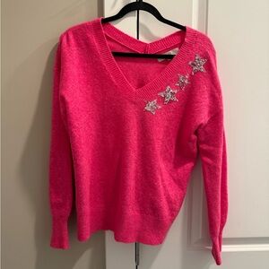 Pink sweater with silver star embellishments